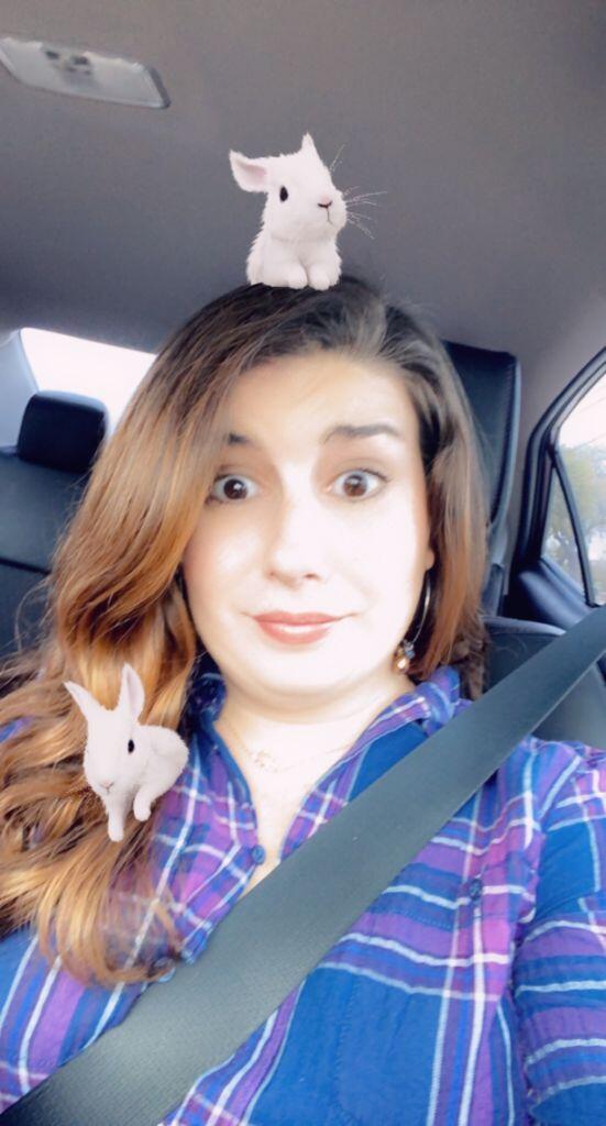 Adoption specialist Alicia, in her car wearing a plaid shirt with bunnies
