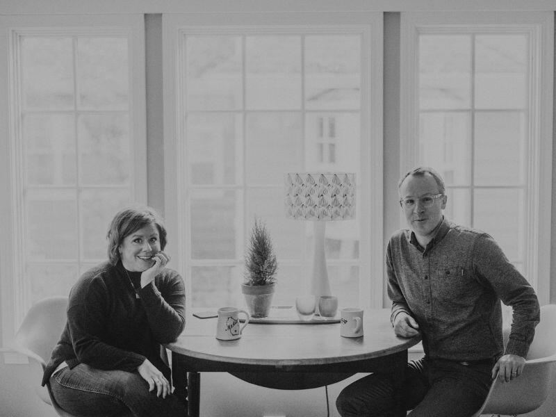 Rachel and Jason sitting at the breakfast table with coffee mugs