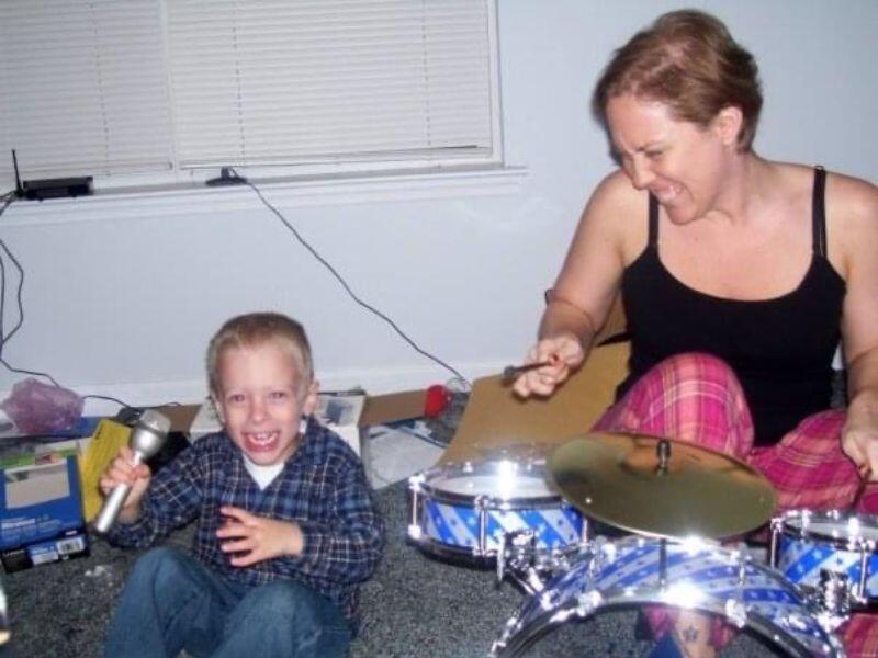 Adoptive mom playing drums with young nephew