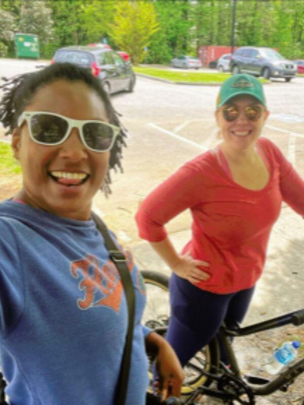 white adoptive mom selfie on bike with black female friend