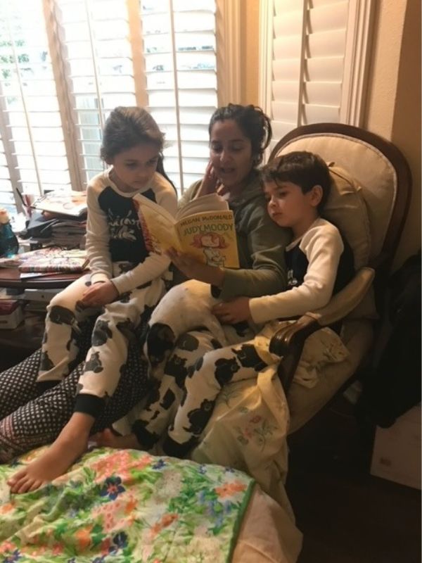 single adoptive mom reading bedtime stories to her niece and nephew