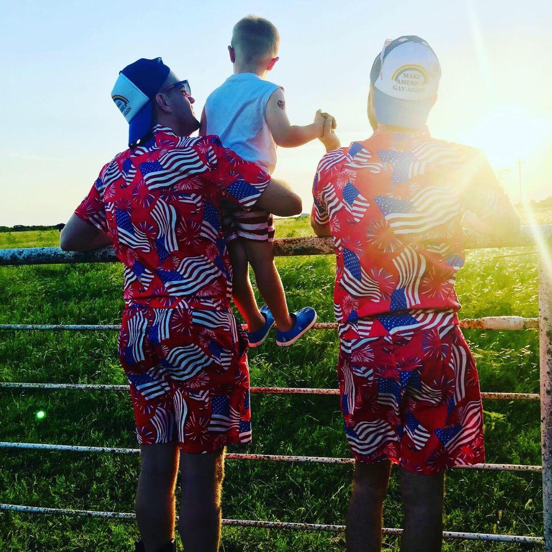 Gay adoptive dads wearing matching american flag outfits