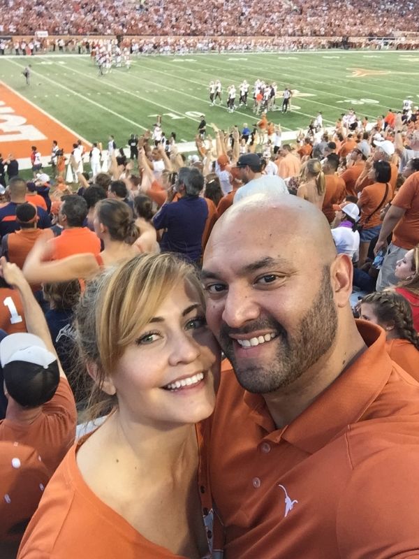 adoptive parents at a UT football game in Austin, TX
