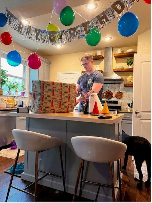 Matt in their kitchen decorated for a birthday