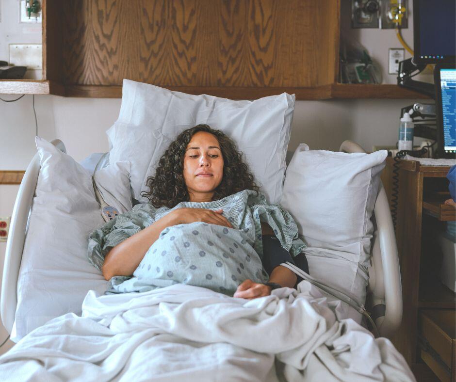 birth mother in labor in a hospital bed