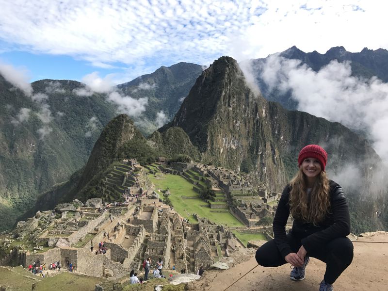 white adoptive mom hiking with machu pichu in the background