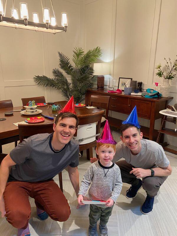 Adoptive family wearing birthday party hats in their Houston home