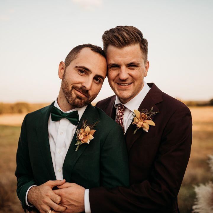 LGBT adoptive parents Micah and Blake in matching green velvet suits