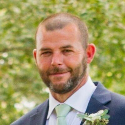 Ben, Houston adoptive parent, in a tuxedo at an outdoor wedding