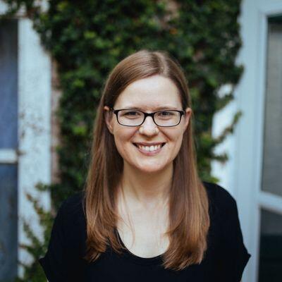 White adoptive mom with long, light brown hair and glasses