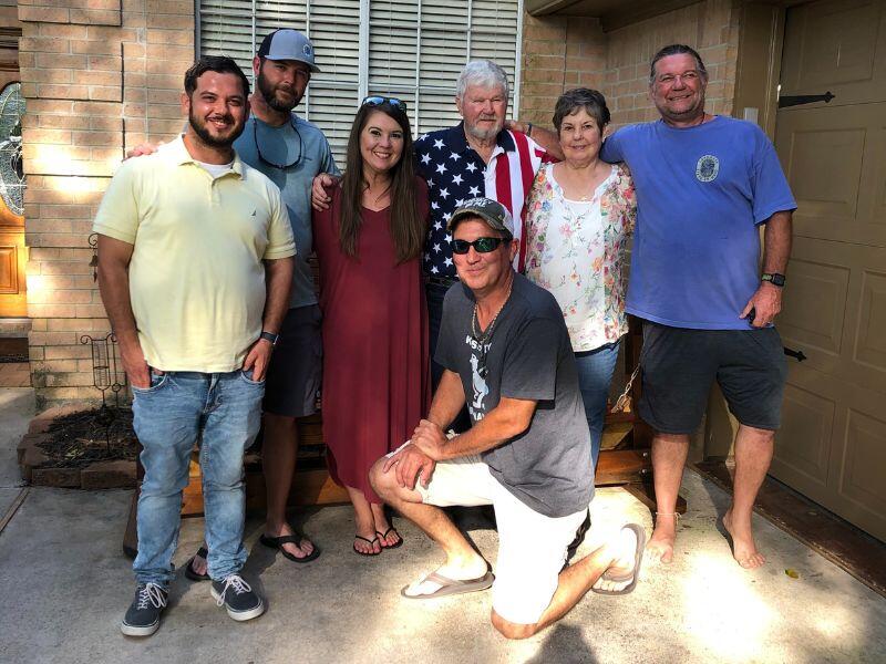 Houston, TX adoptive parents with family at wedding