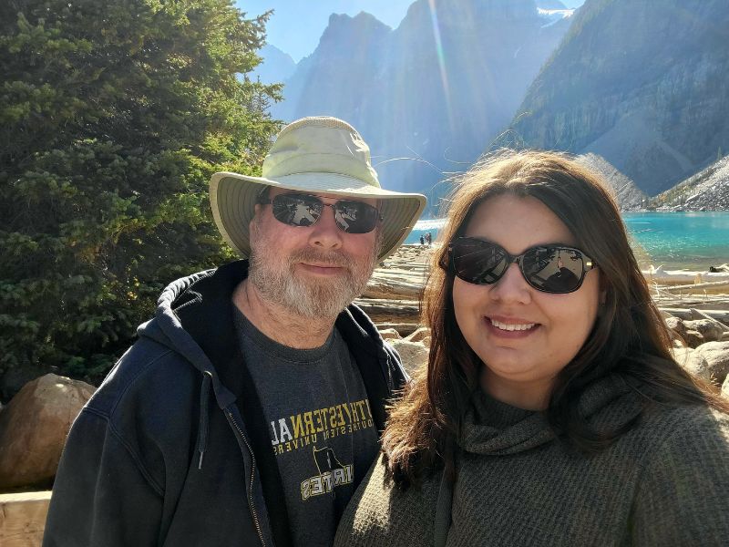 Houston adoptive parents outside in a canyon with river in background