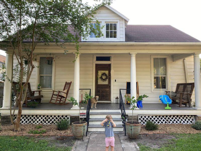 one-story house with white siding and wide front porch