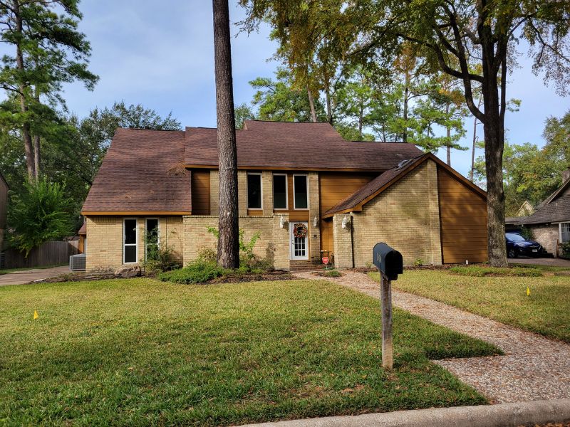 Brick home with large yard and lots of trees
