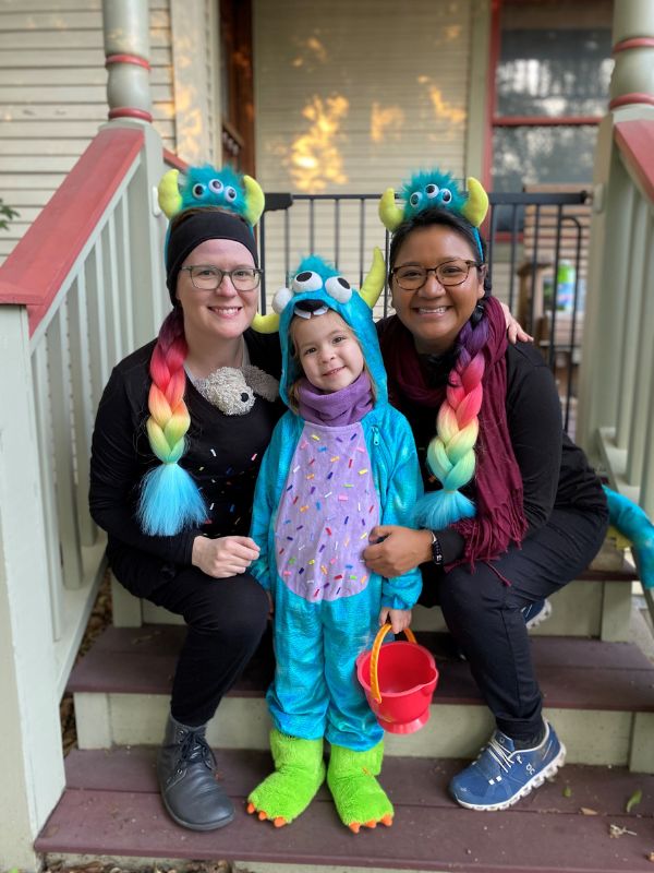 houston lgbt adoptive family wearing monsters hats on their front porch