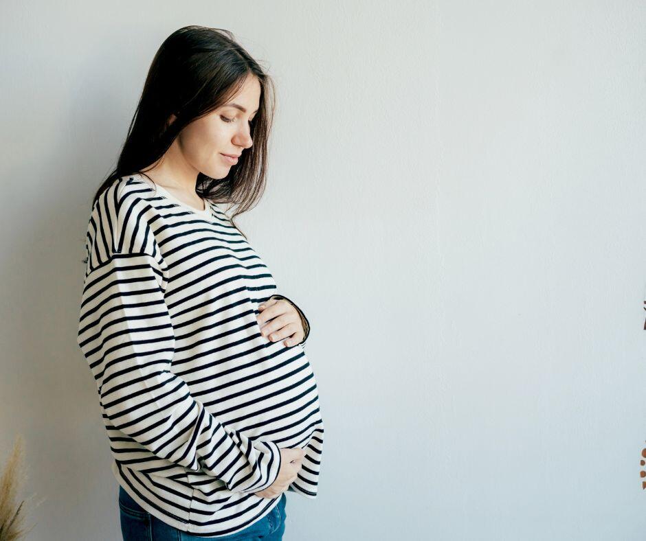 Pregnant woman cradling belly