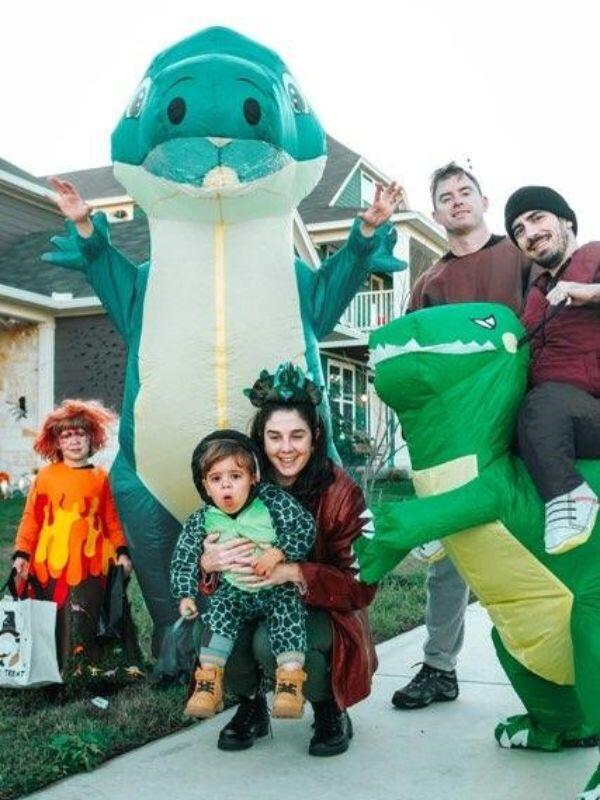 Austin adoptive parents sitting on an orange couch outdoors