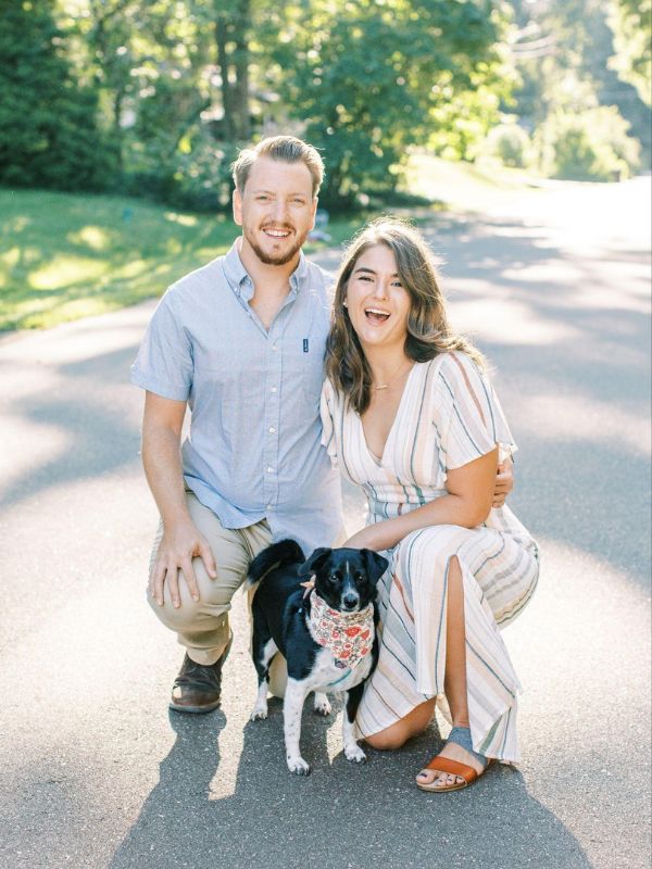 Jennifer and Marty with Allie, a smallish black and white dog wearing a bandana