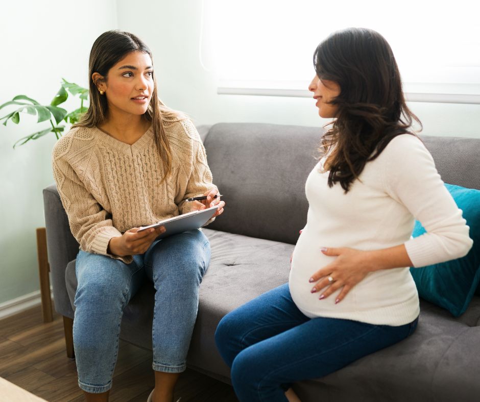 pregnant woman receiving counseling from a social worker