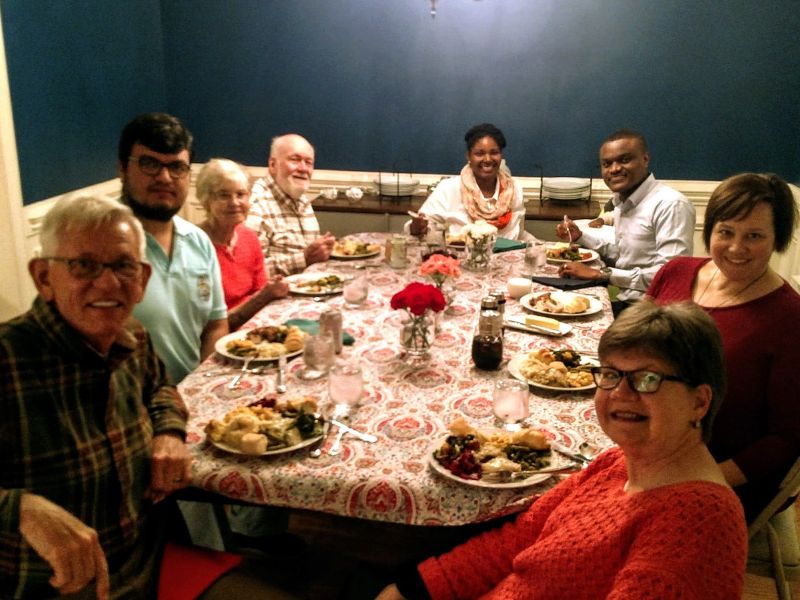 Adoptive parents hosting thanksgiving with family and friends in their home