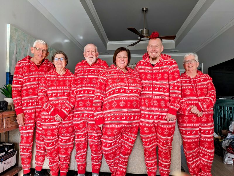 extended adoptive family in matching red christmas pajamas