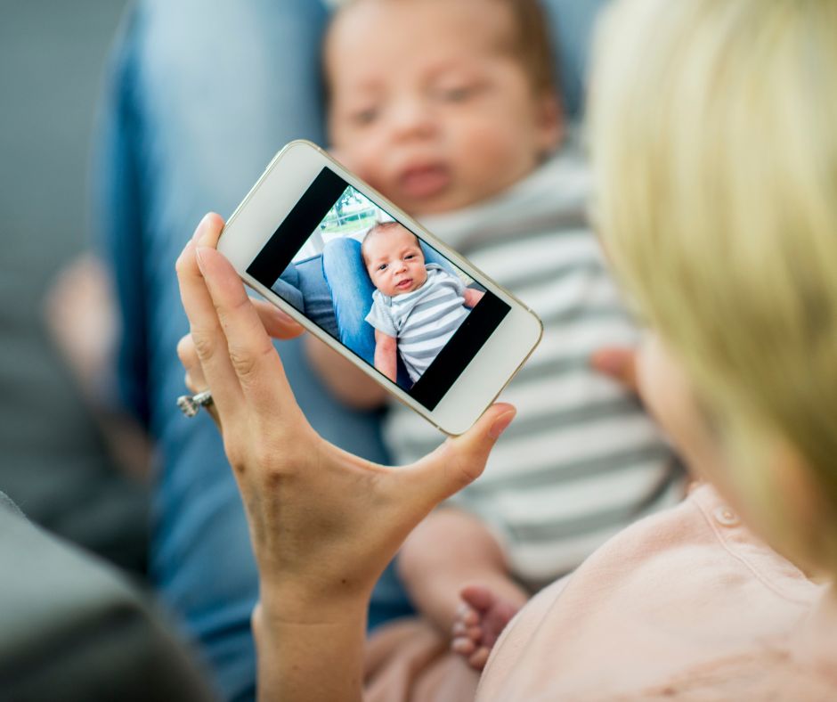 Adoptive mom taking picture of baby for social media