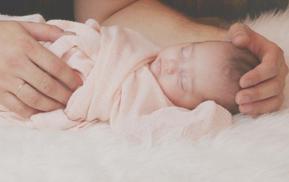 sleeping baby in pink swaddle
