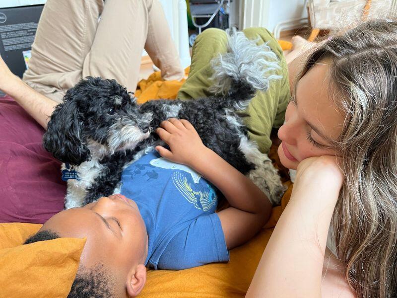 Adoptive parents' kids with small black and white dog