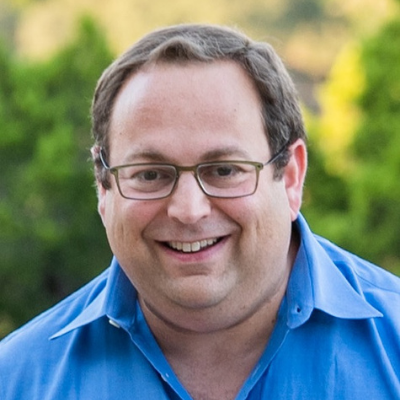 Gary, an Austin parent waiting to adopt a baby, outdoors in a blue shirt