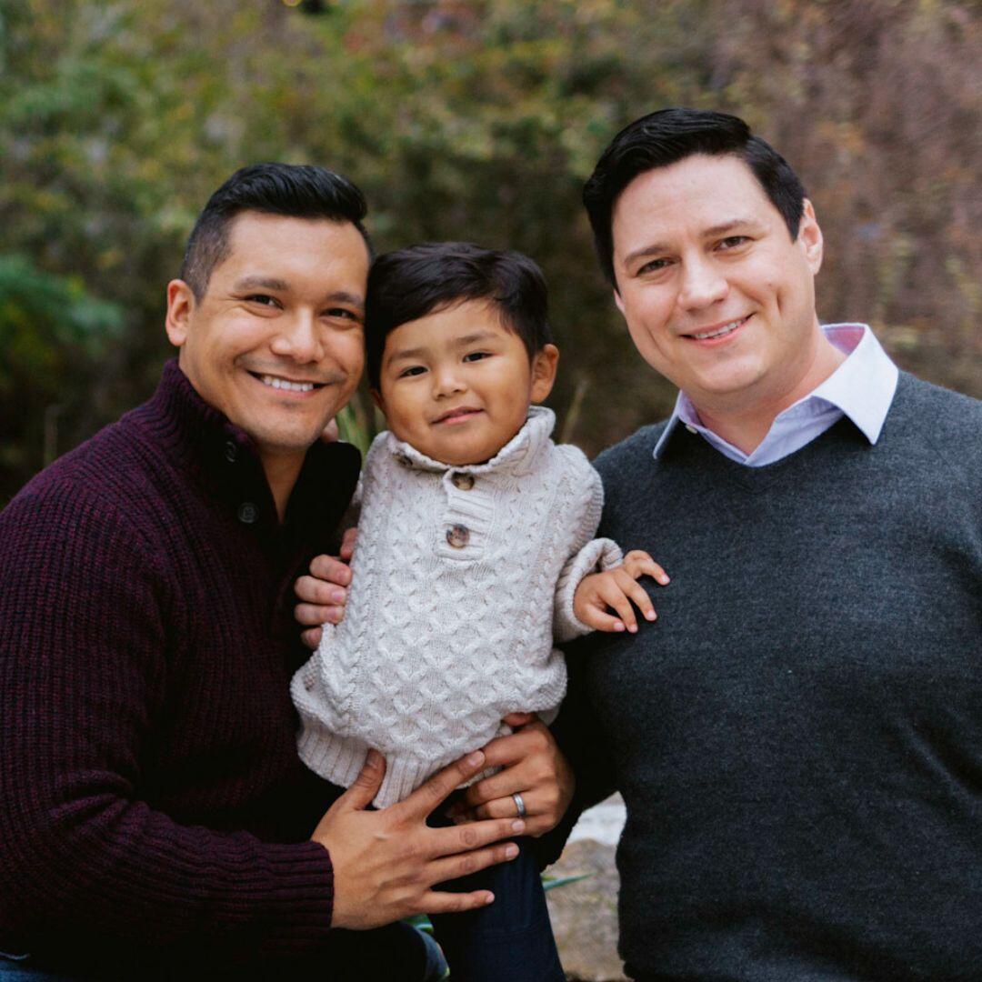 LGBT adoptive parents Ruben and Miguel with their son