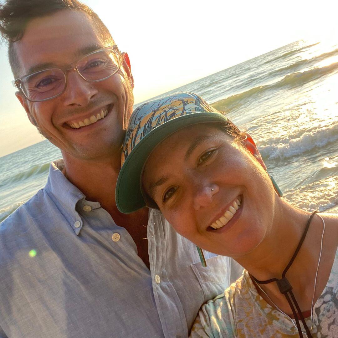 Prospective adoptive parents Susan and Daniel's selfie on the beach at sunset